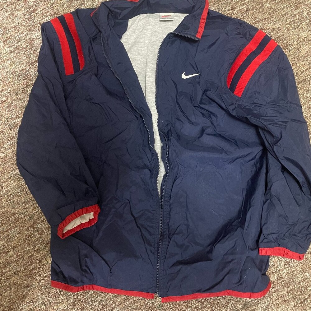 Vintage 90s Nike windbreaker jacket in a navy blue colorway with red stripe